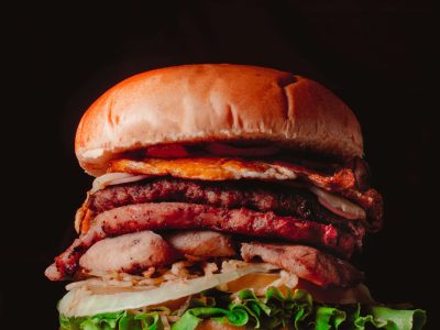 Mouth-watering gourmet burger stacked with fresh ingredients and savory meats.